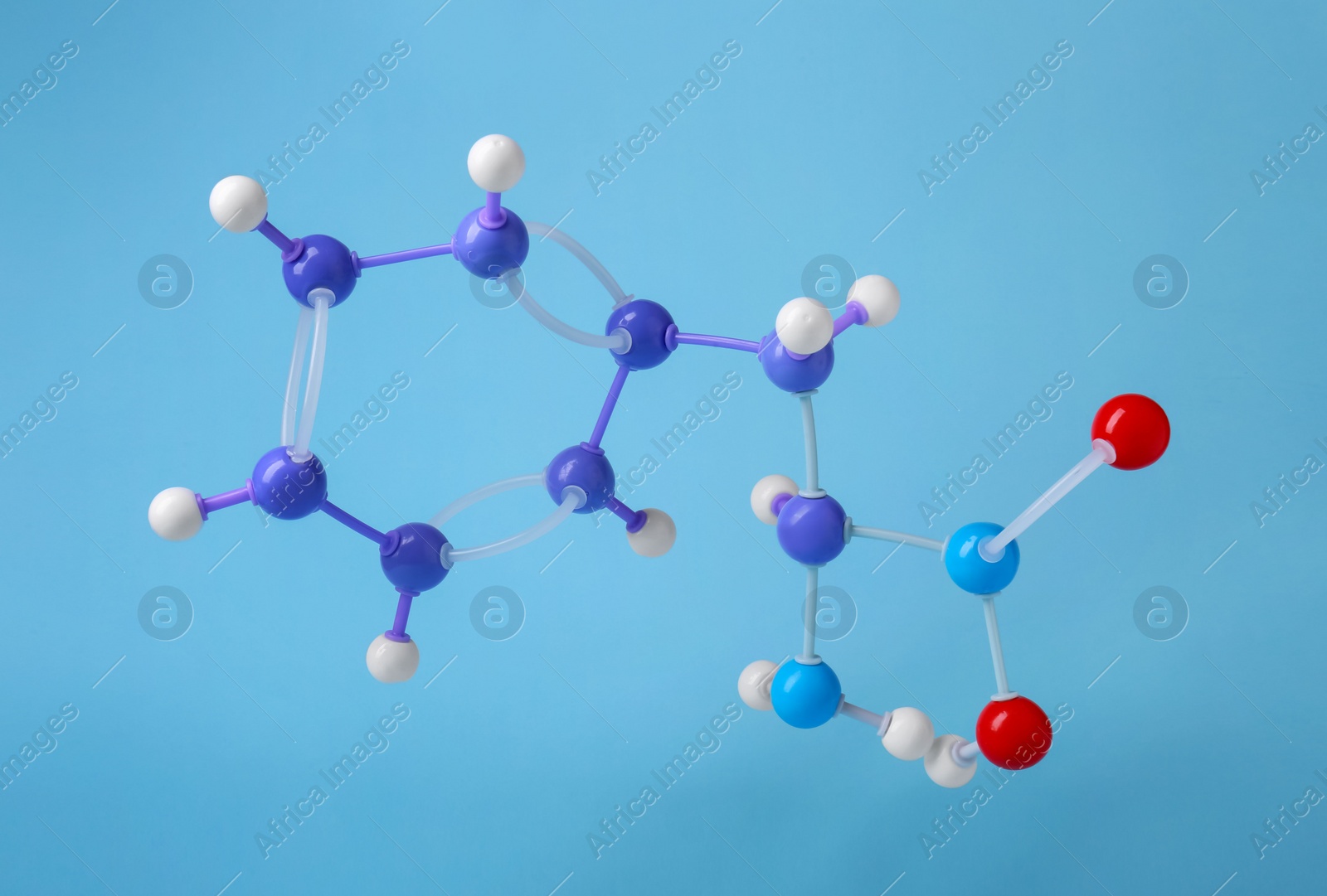 Photo of Molecule of phenylalanine on light blue background. Chemical model
