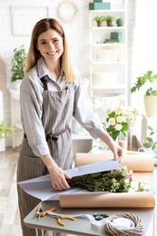 Photo of Female florist creating bouquet at workplace