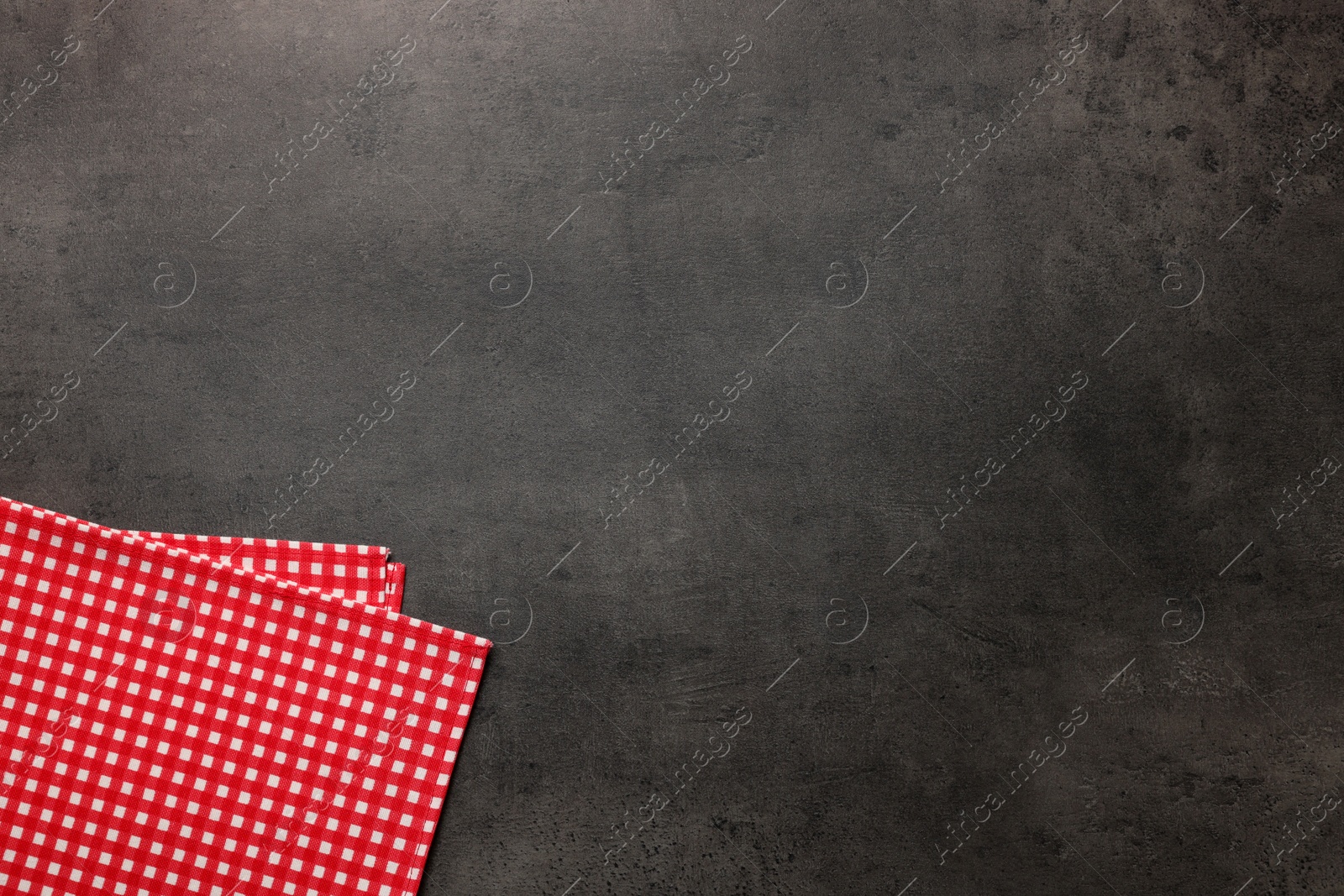 Photo of Checkered tablecloth on grey background, top view. Space for text