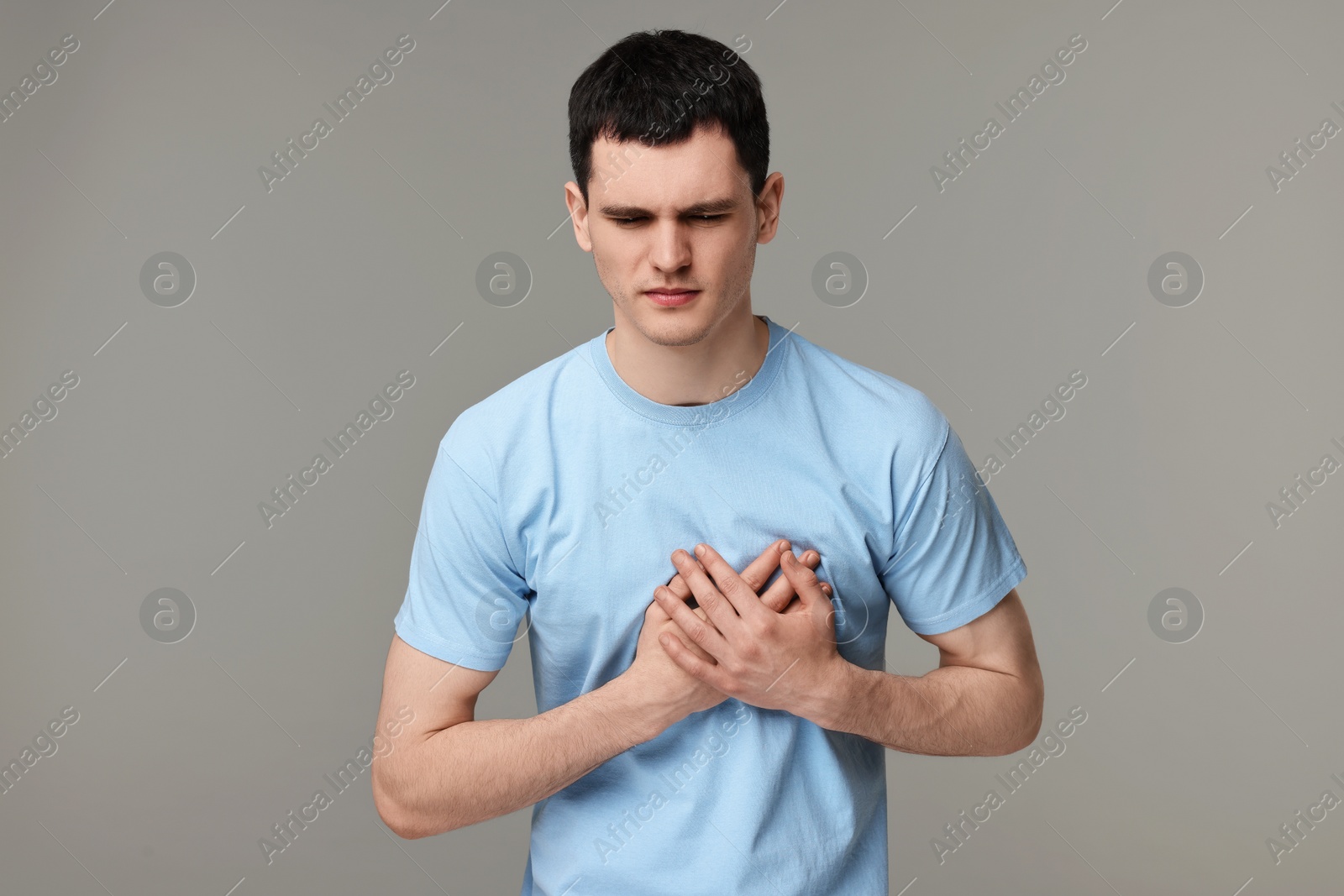 Photo of Man suffering from heart hurt on grey background