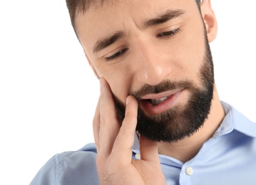 Photo of Young man suffering from toothache on white background
