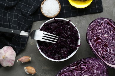 Photo of Tasty red cabbage sauerkraut and different ingredients on light grey table, flat lay