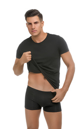 Photo of Handsome man in black underwear and t-shirt on white background