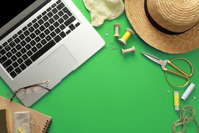 Flat lay composition with laptop on green background. Blogger's workplace