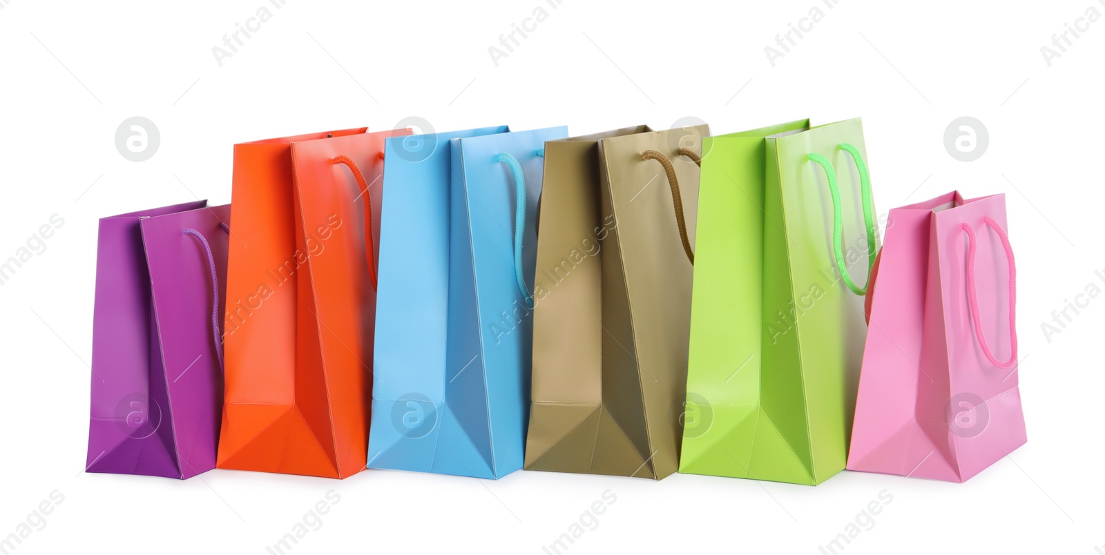 Photo of Colorful paper shopping bags isolated on white