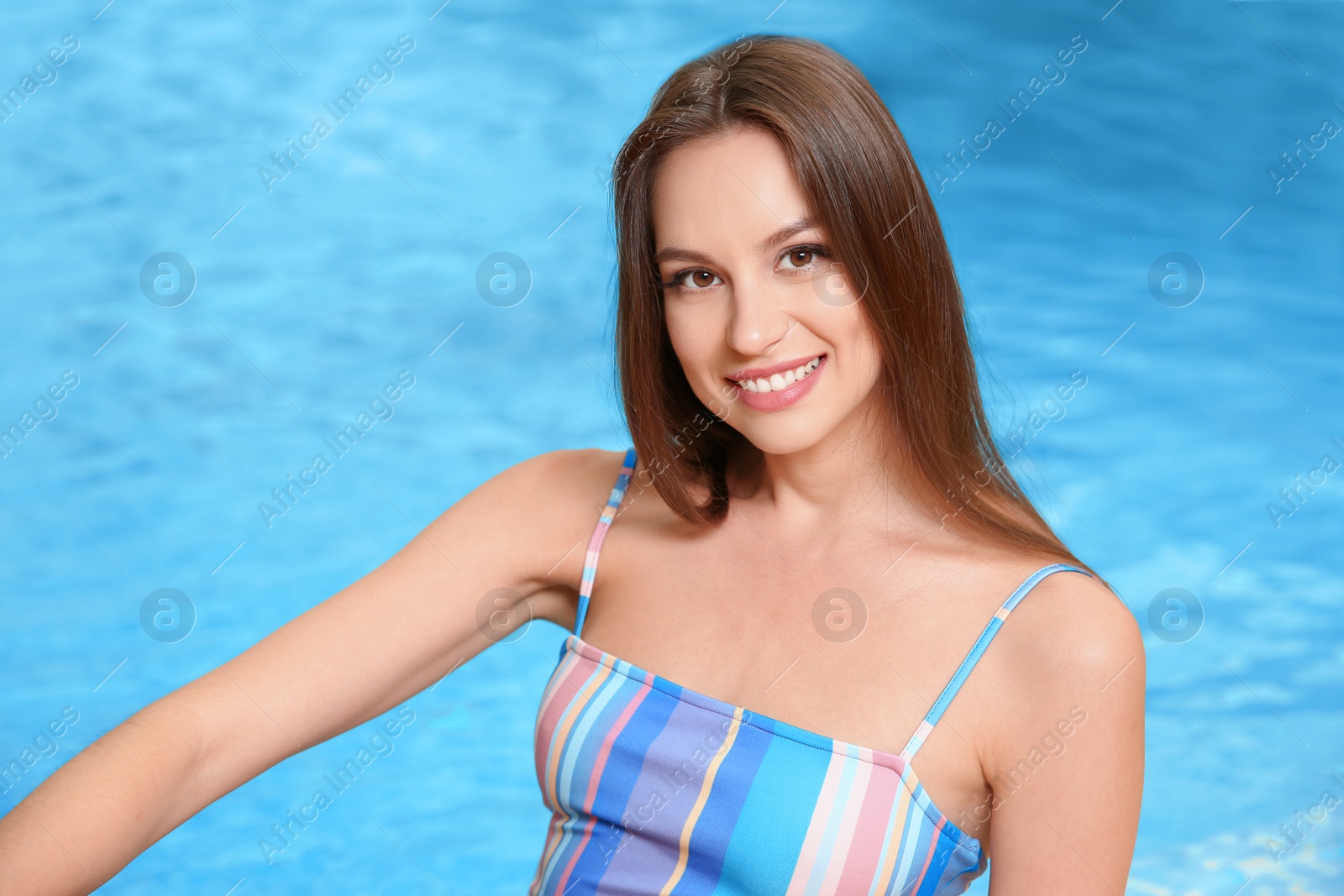 Photo of Portrait of beautiful young woman near swimming pool