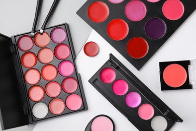 Photo of Flat lay composition with cream lipstick palettes on color background. Professional cosmetic product