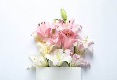 Photo of Composition with beautiful blooming lily flowers on white background