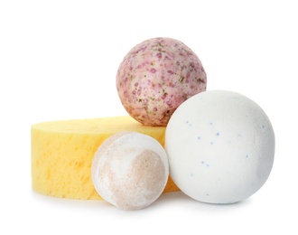 Bath bombs and sponge on white background