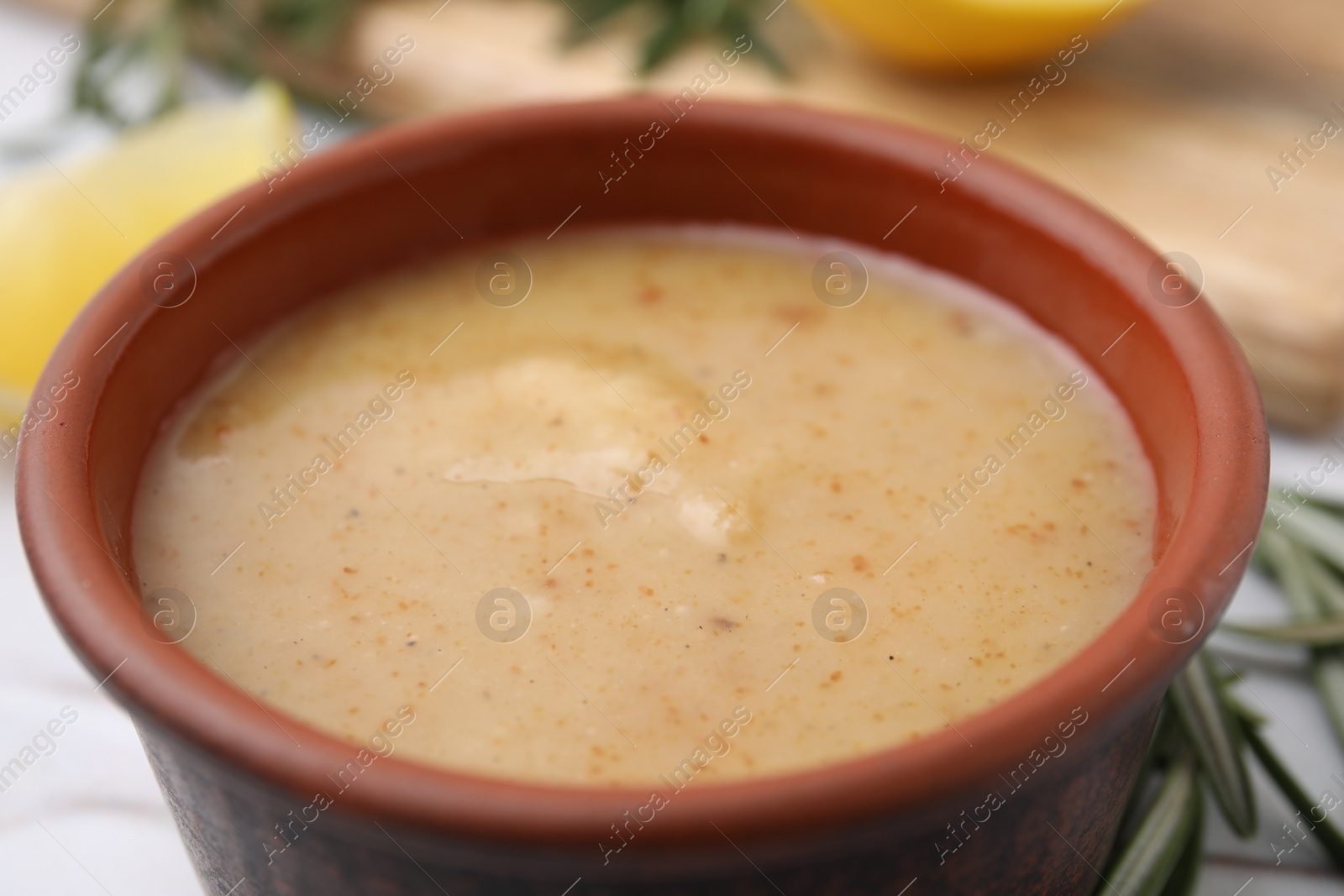 Photo of Delicious turkey gravy in bowl on table, closeup