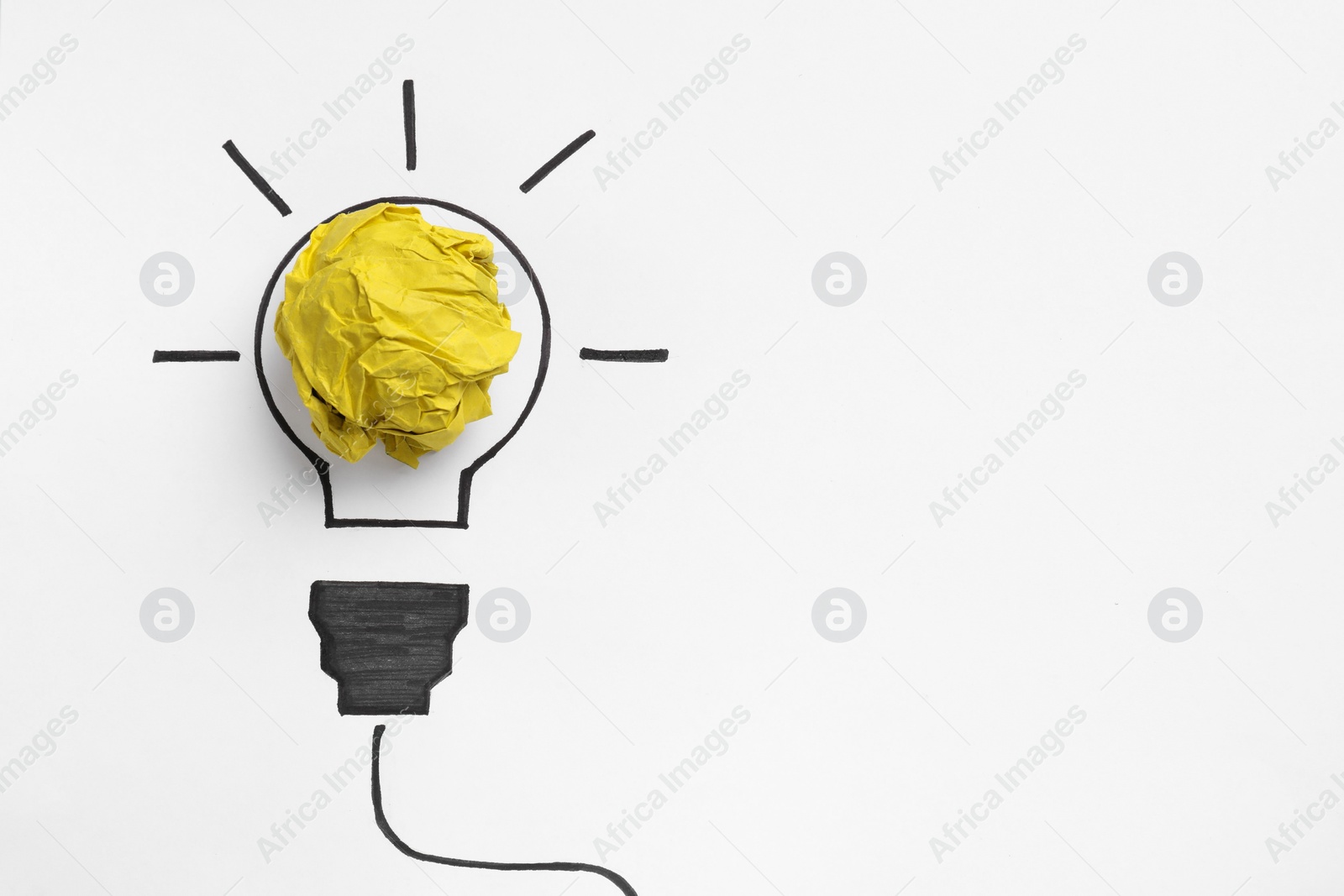 Photo of Idea concept. Light bulb made with crumpled paper and drawing on white background, top view. Space for text