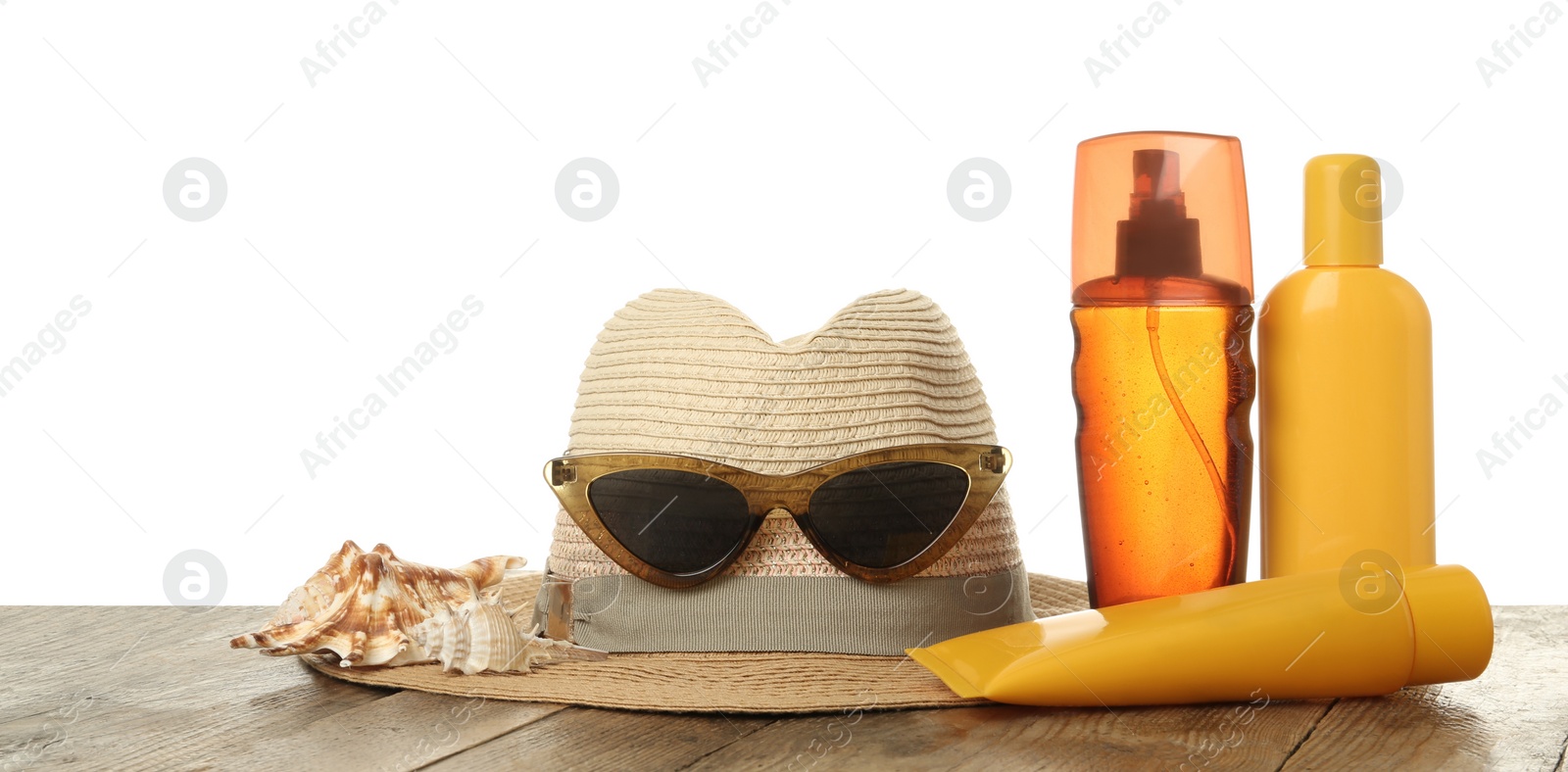 Photo of Sun protection products and beach accessories on wooden table