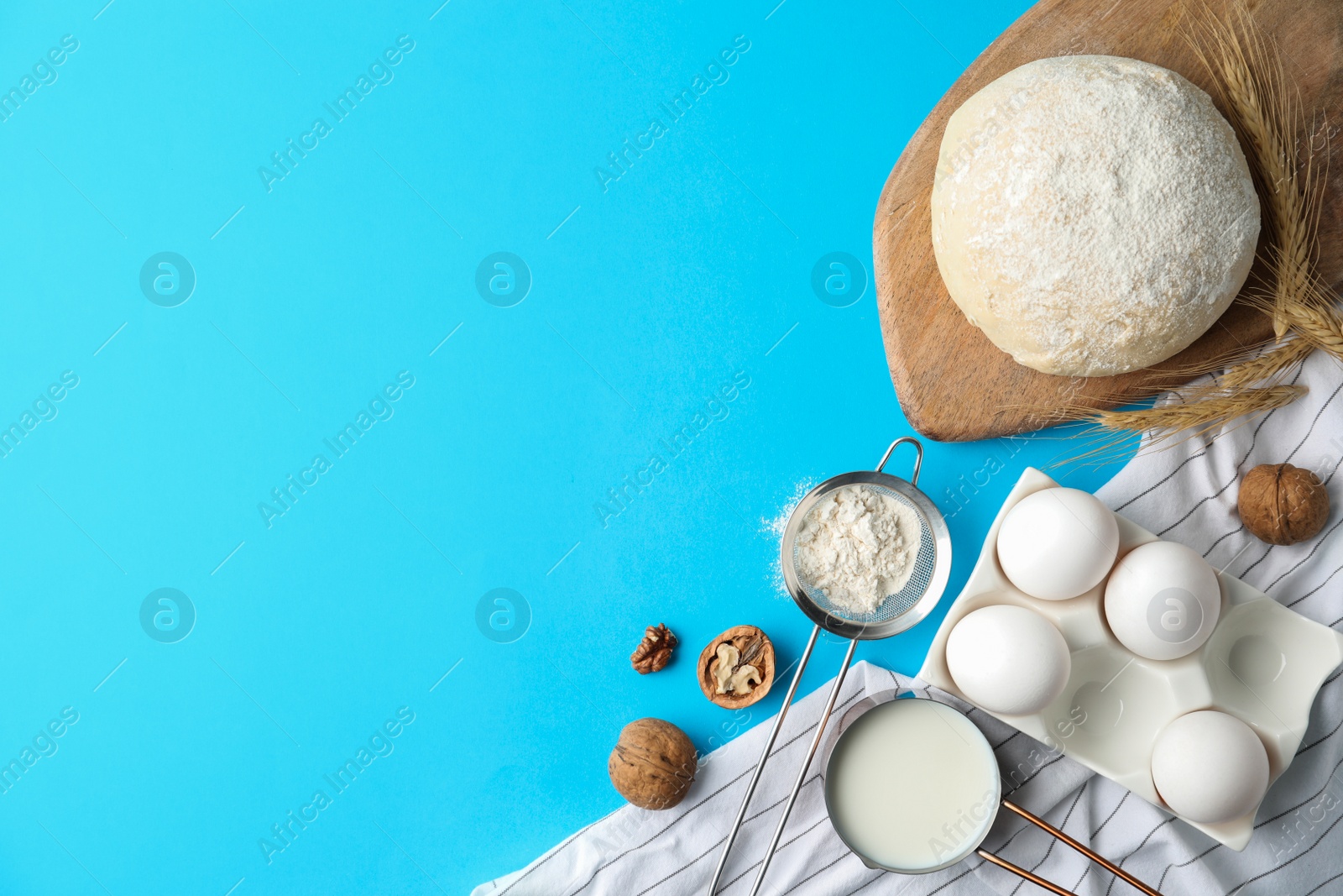 Photo of Flat lay composition with dough on blue background, space for text. Cooking pastries