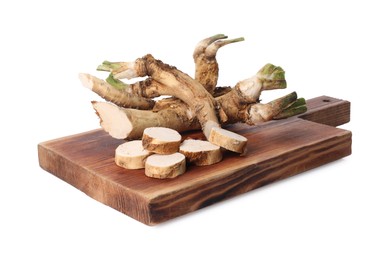 Photo of Board with fresh cut horseradish roots isolated on white