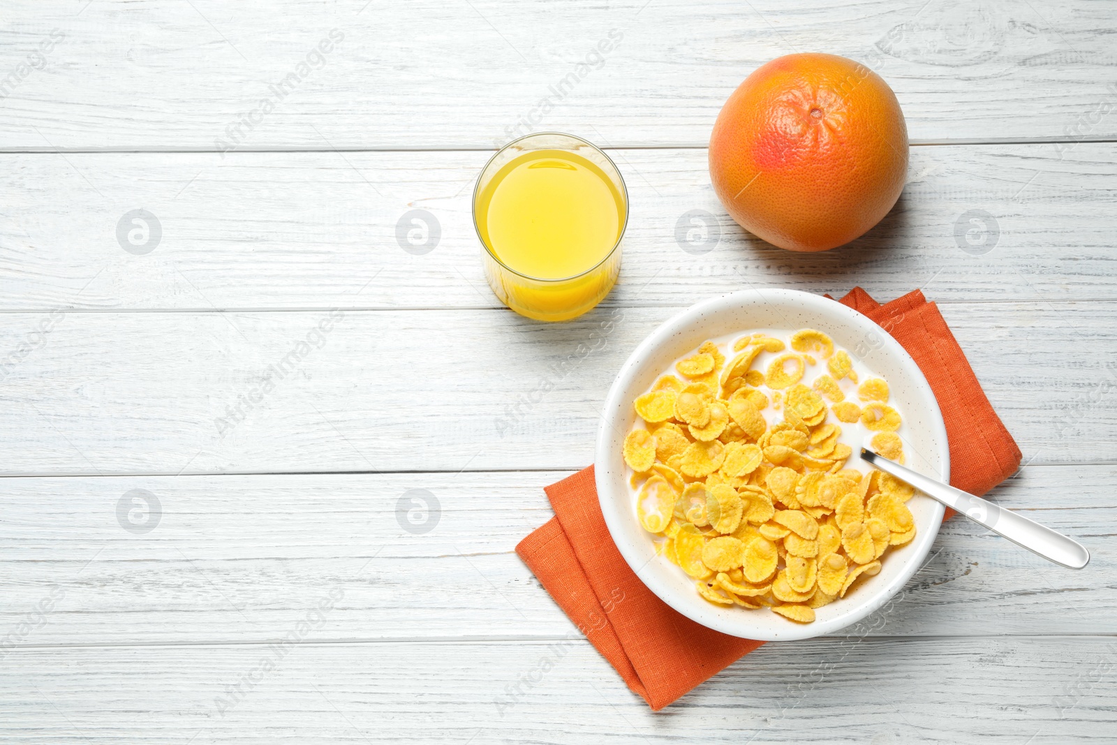 Photo of Flat lay composition with tasty corn flakes on white wooden table. Space for text