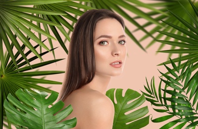 Image of Beautiful young woman and tropical leaves. Spa portrait