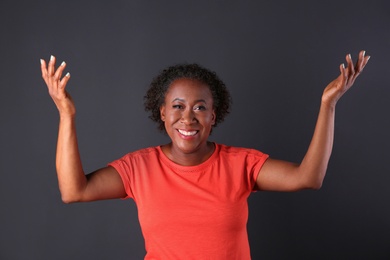 Photo of Portrait of happy African-American woman on black background