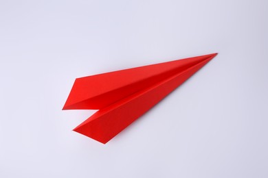 Photo of Origami art. Paper plane on white background, top view