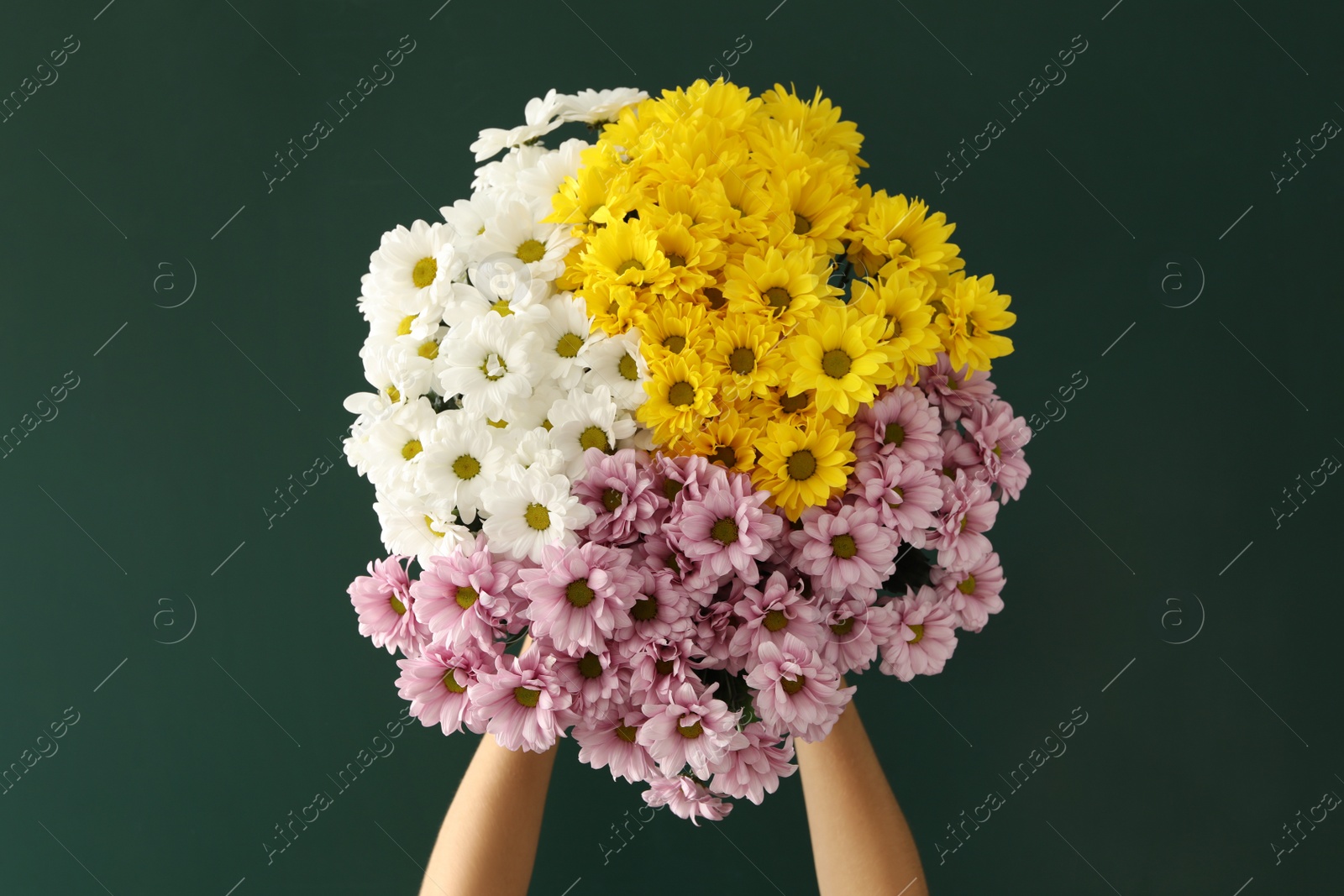 Photo of Woman holding beautiful bouquet near green chalkboard. Happy Teacher's Day