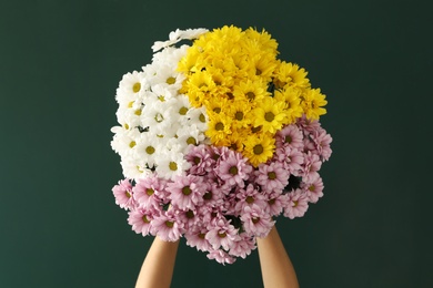 Woman holding beautiful bouquet near green chalkboard. Happy Teacher's Day