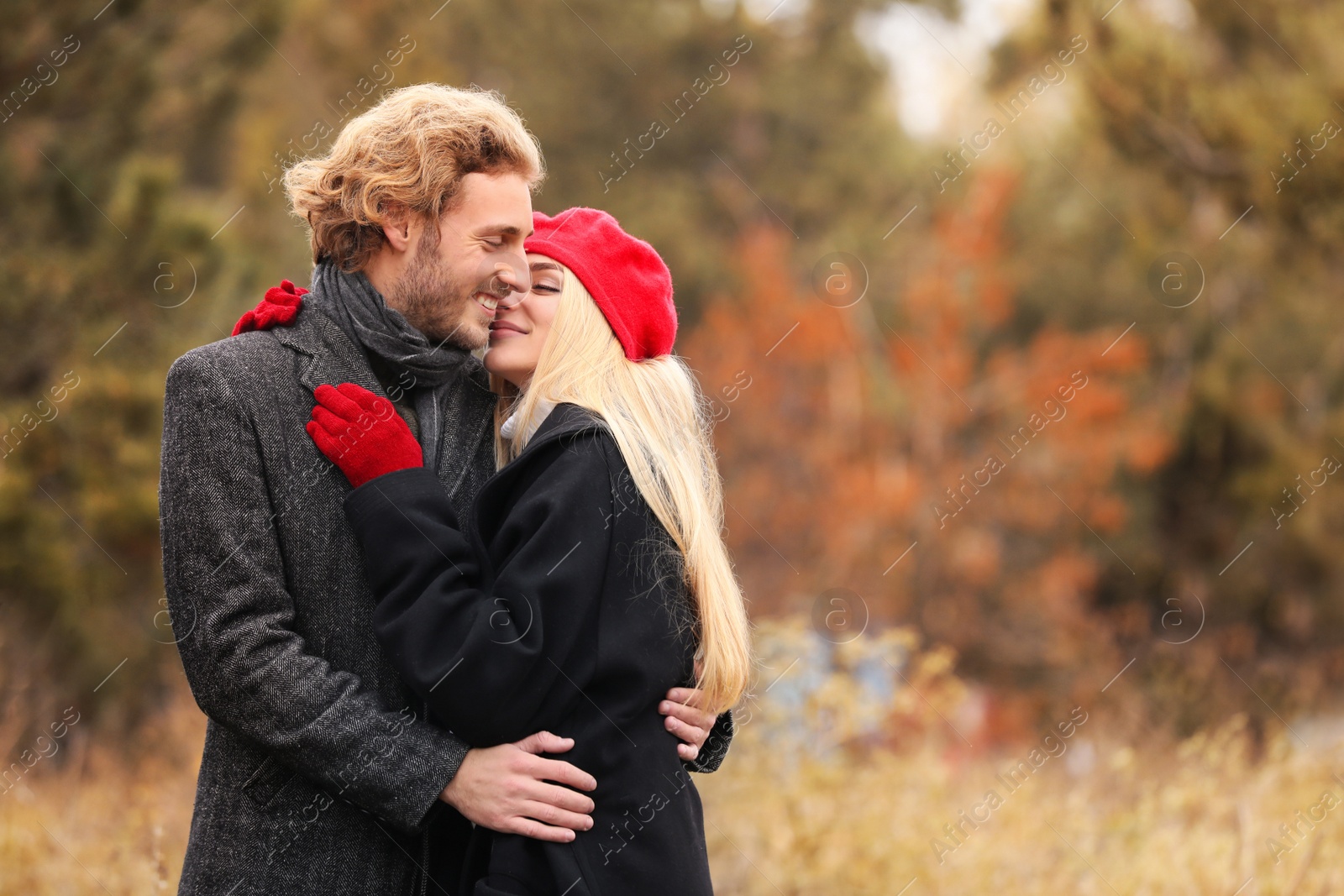 Photo of Young romantic couple in park on autumn day