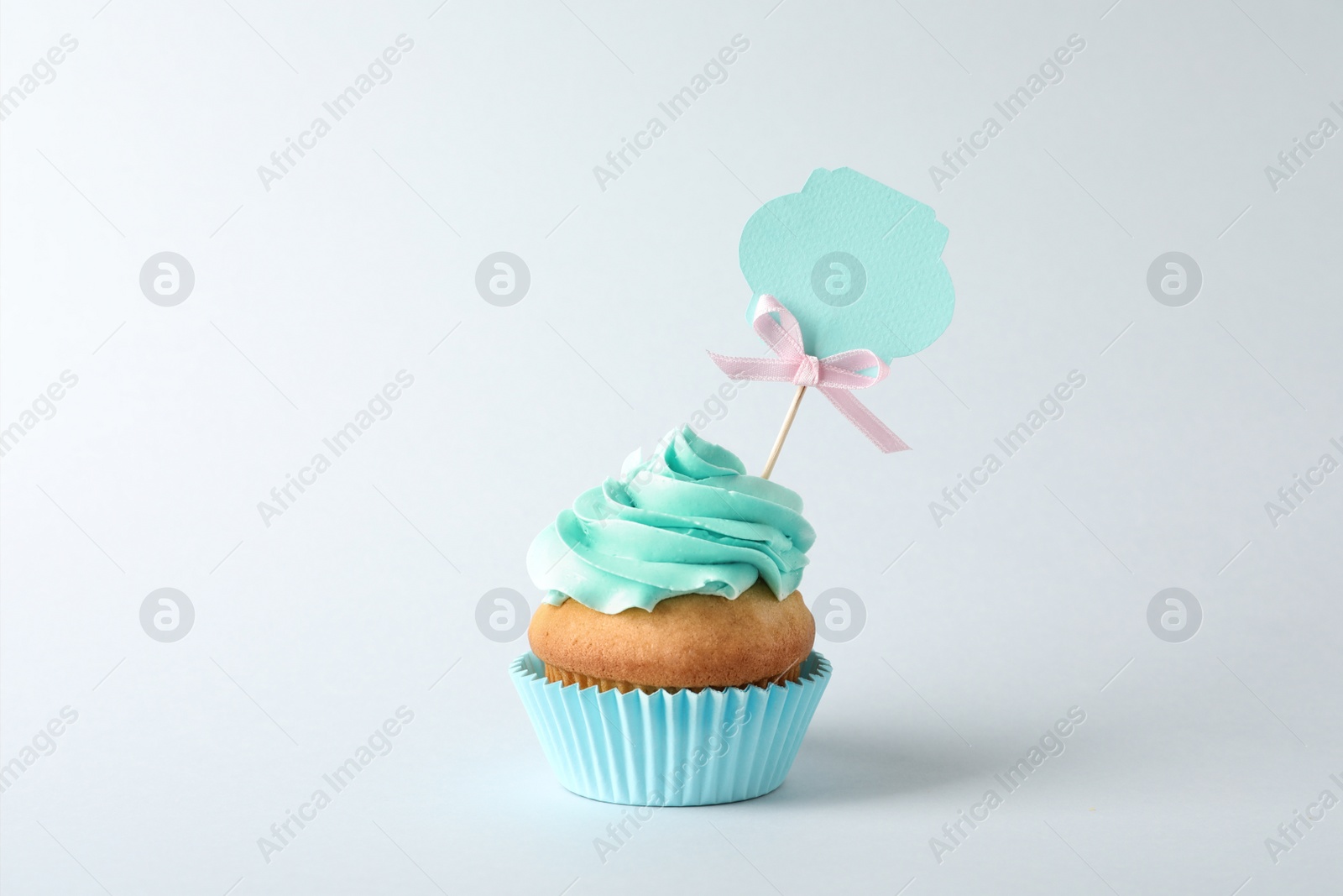 Photo of Delicious birthday cupcake on gray background
