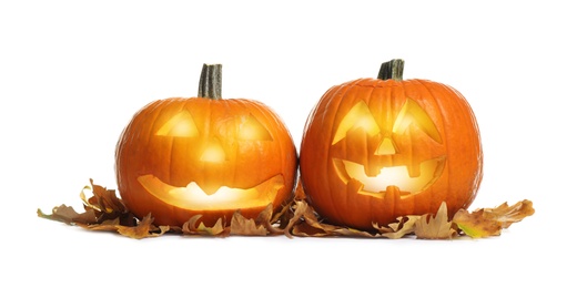 Photo of Cute pumpkin jack o'lanterns and autumn leaves on white background. Halloween decor