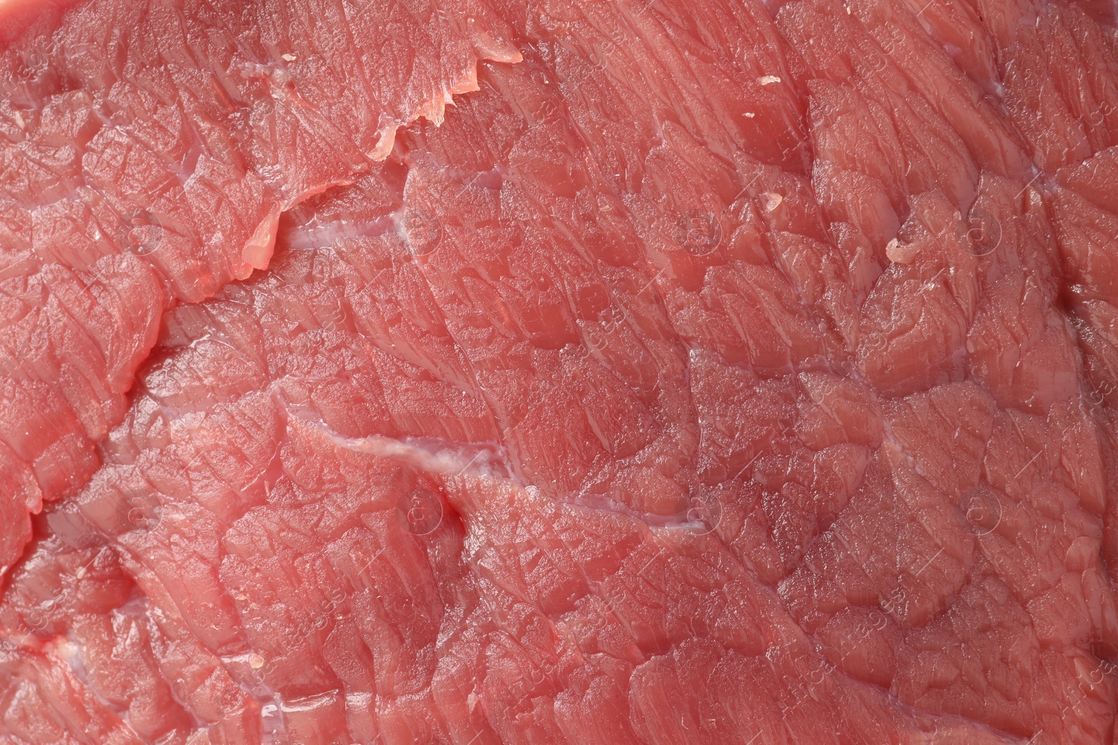 Photo of Piece of raw beef meat as background, closeup