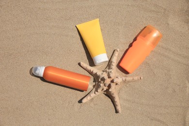 Flat lay composition with sunscreens on sand. Sun protection care