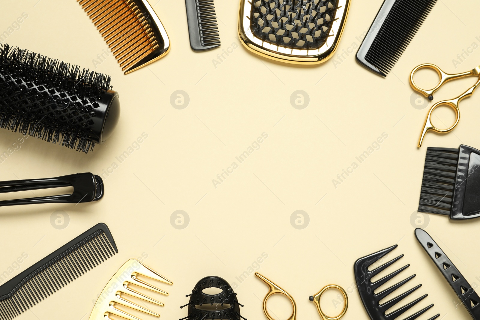 Photo of Frame of hairdressing tools on beige background, flat lay. Space for text