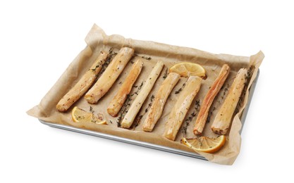 Photo of Baking tray with cooked salsify roots, lemon and thyme isolated on white