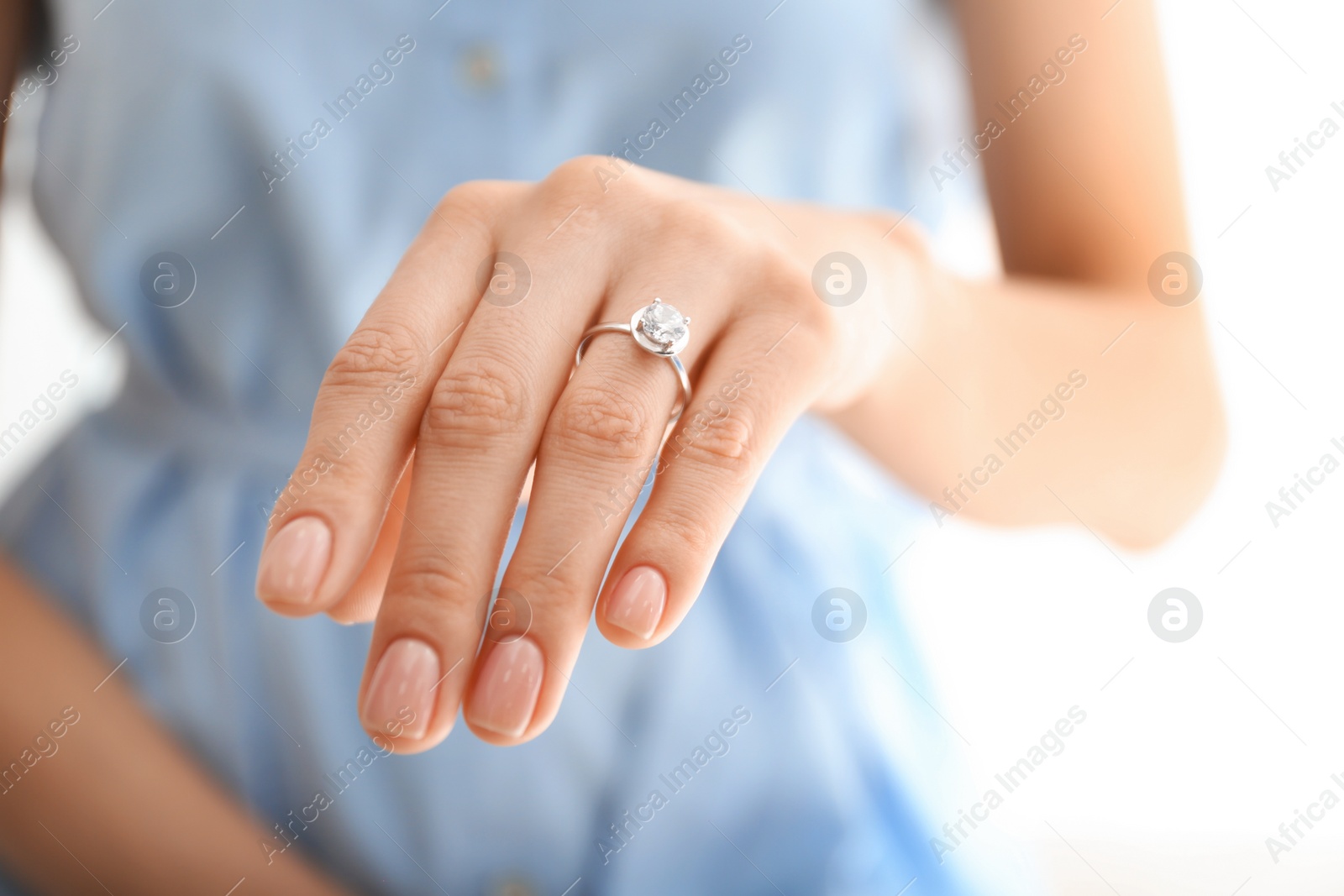 Photo of Young woman wearing beautiful engagement ring, closeup