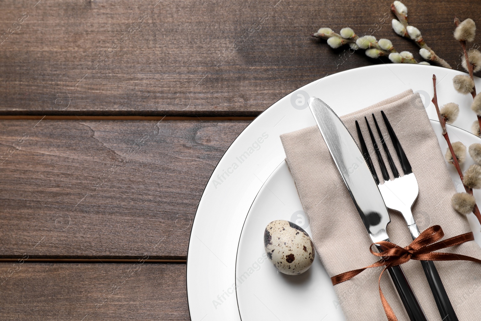 Photo of Festive Easter table setting with egg on wooden background, top view. Space for text