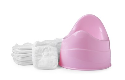 Pink baby potty and stacks of diapers isolated on white. Toilet training