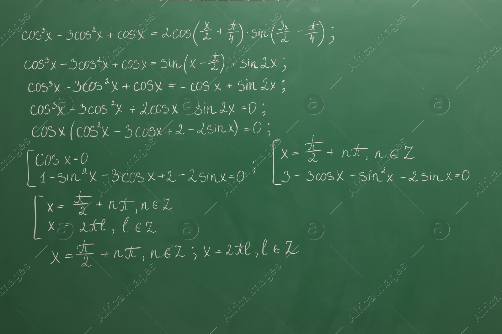 Photo of Many different math formulas written on green chalkboard