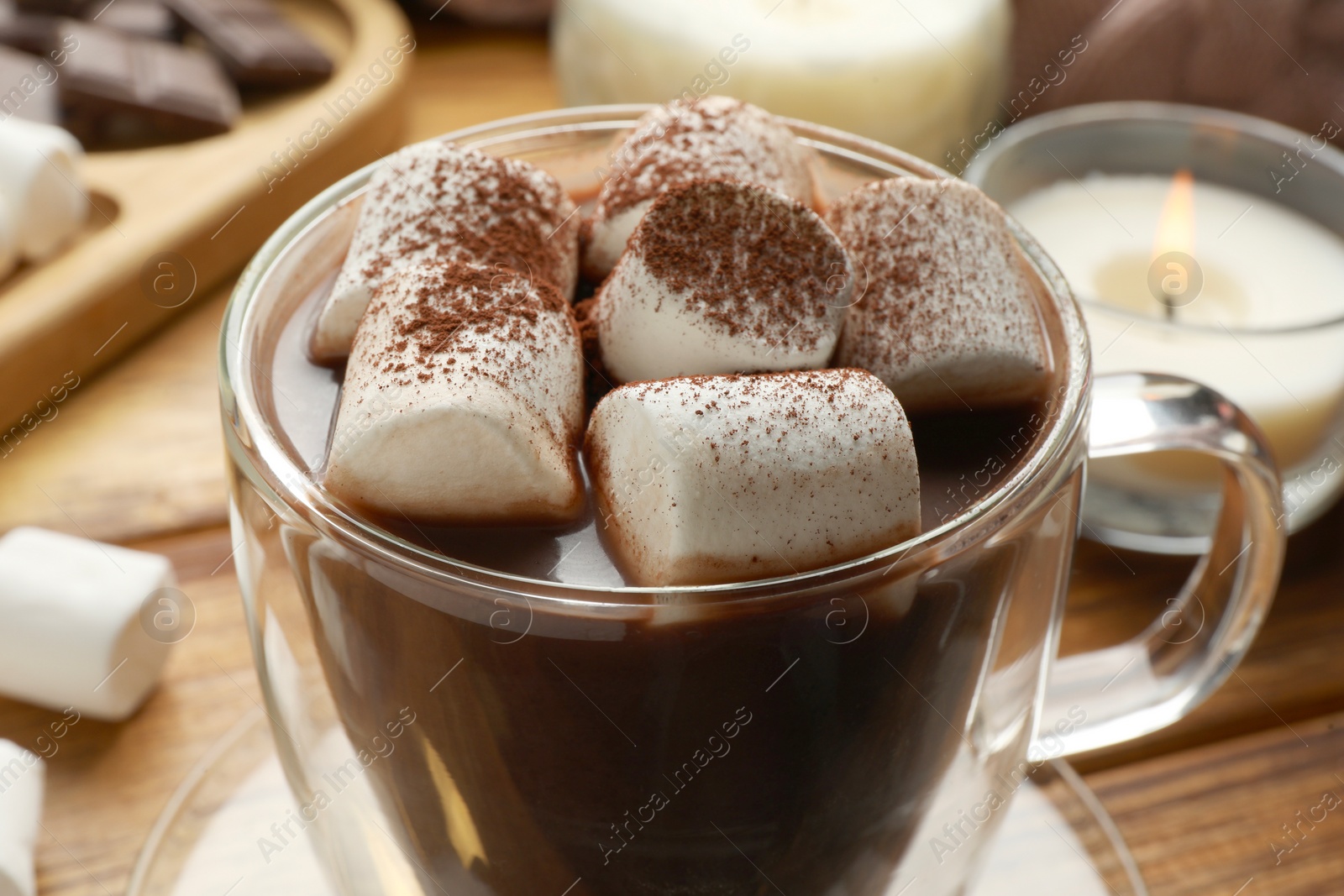 Photo of Cup of aromatic hot chocolate with marshmallows and cocoa powder on table, closeup