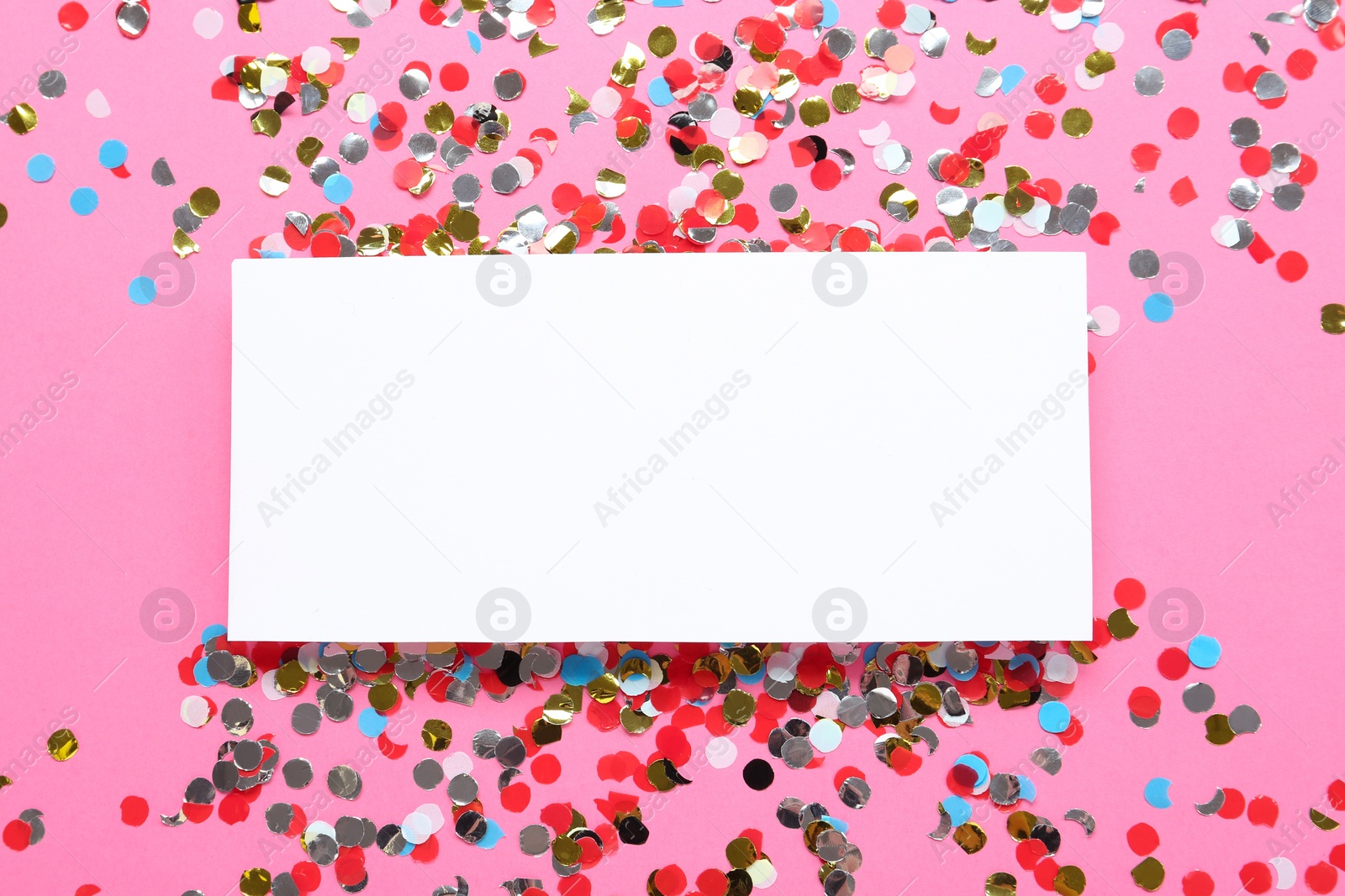 Photo of Blank card and shiny colorful confetti on pink background, flat lay. Space for text