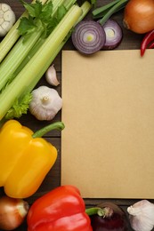 Photo of Blank recipe book and different ingredients on wooden table, flat lay. Space for text