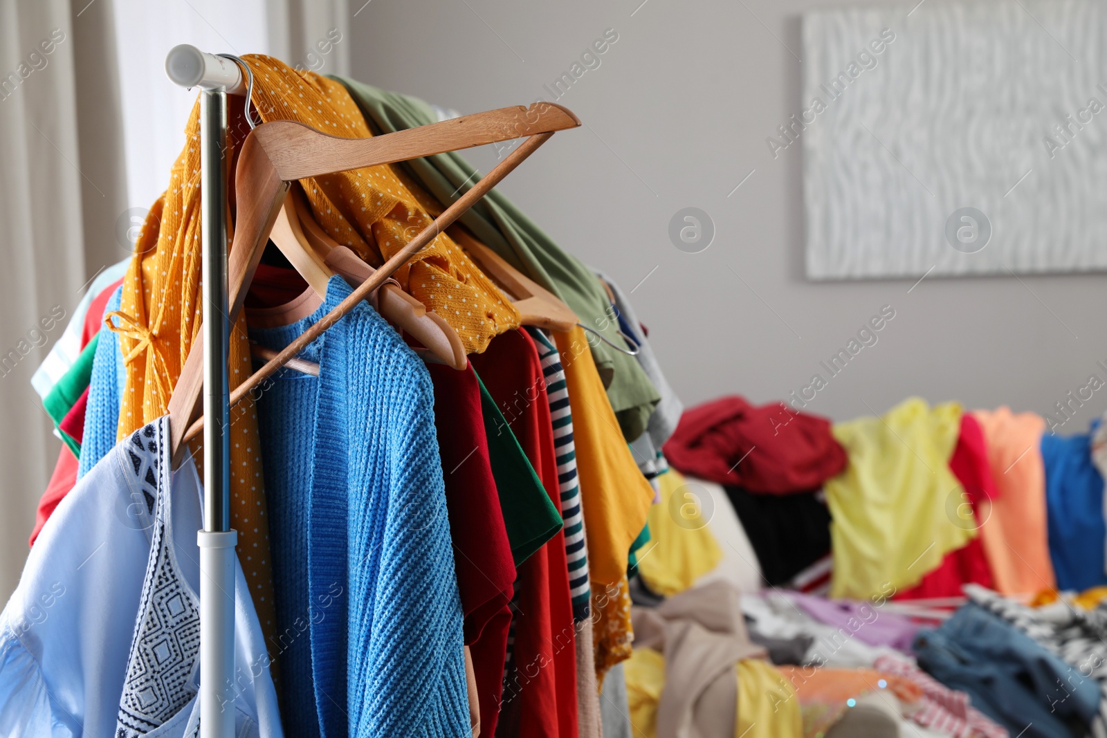 Photo of Mess of clothes all over room. Fast fashion