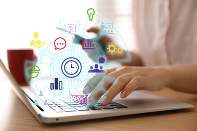 Modern technology concept. Woman working with laptop at wooden table, closeup