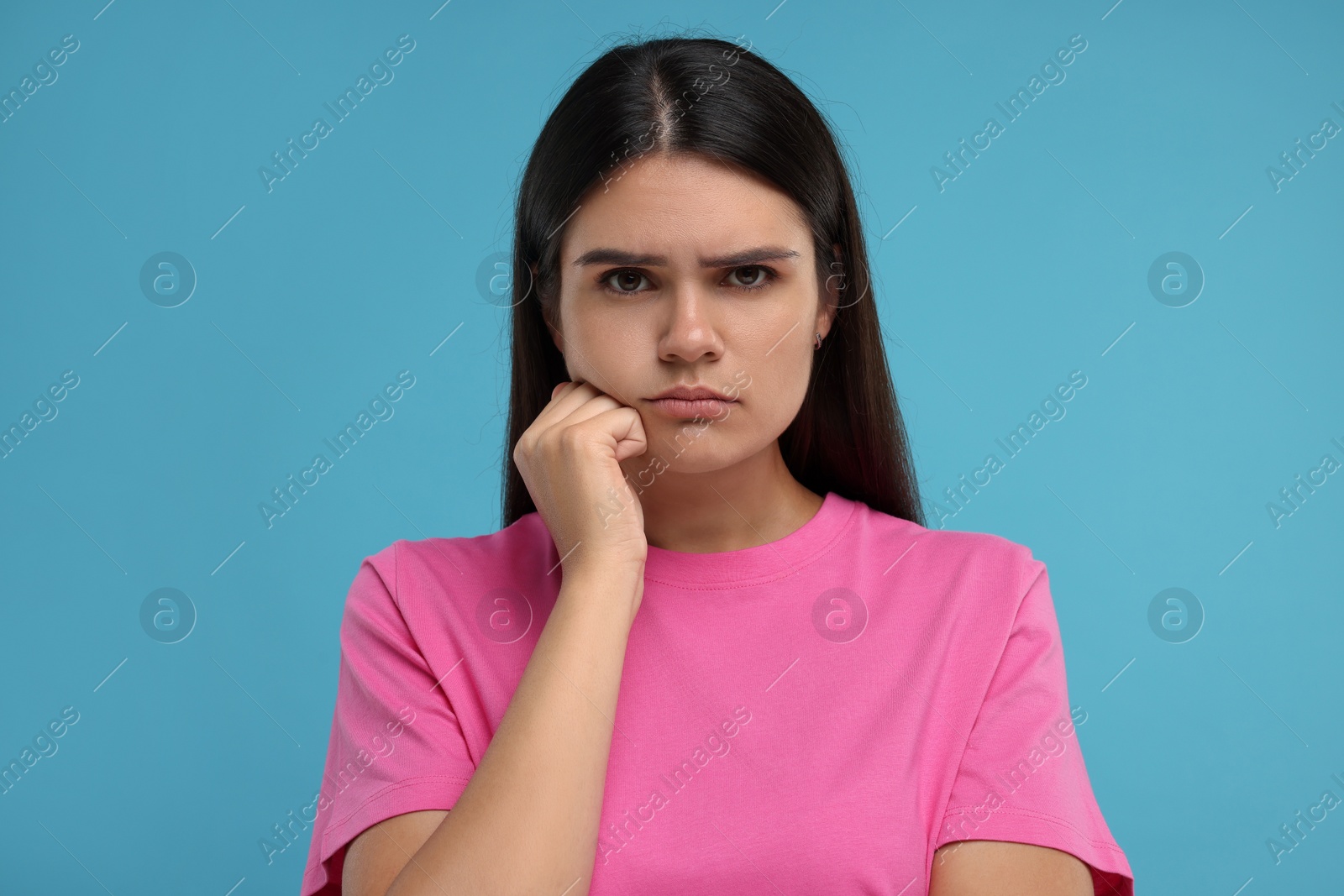 Photo of Portrait of resentful woman on light blue background