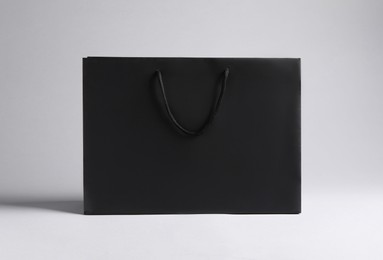 Photo of Black paper bag on light grey background