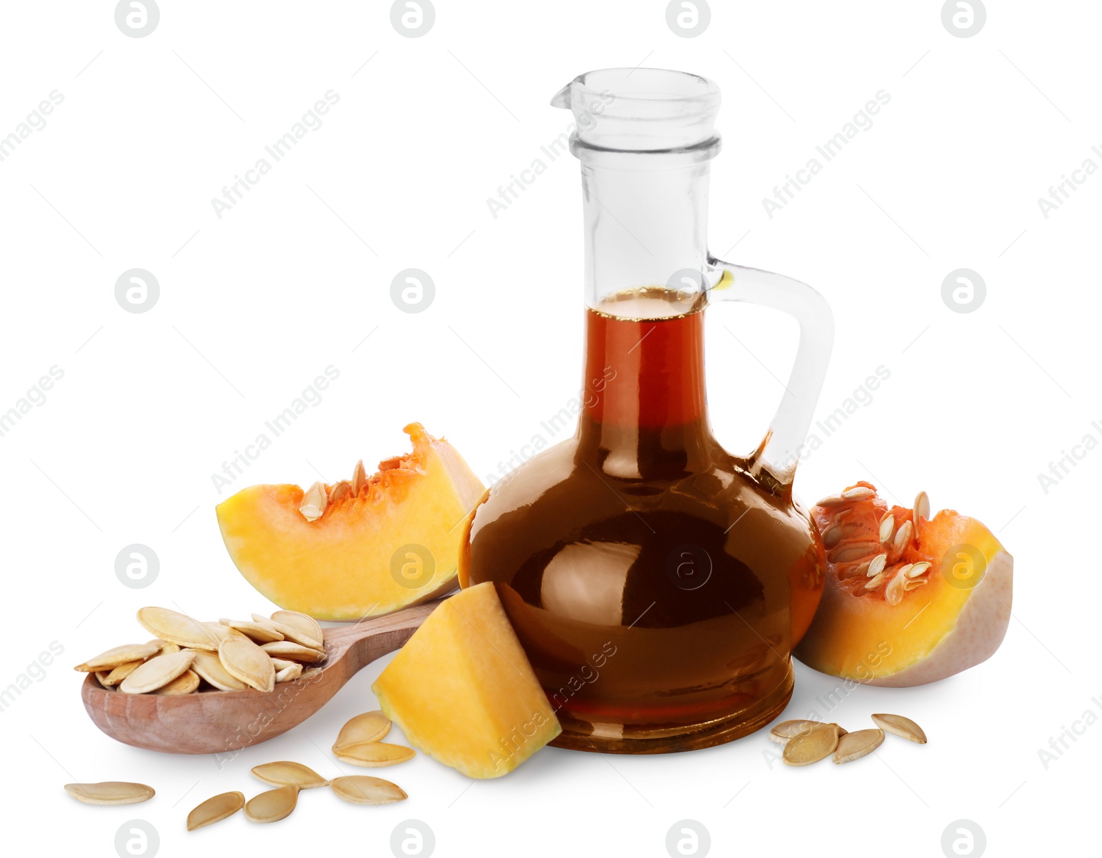 Photo of Fresh pumpkin seed oil in glass jug isolated on white