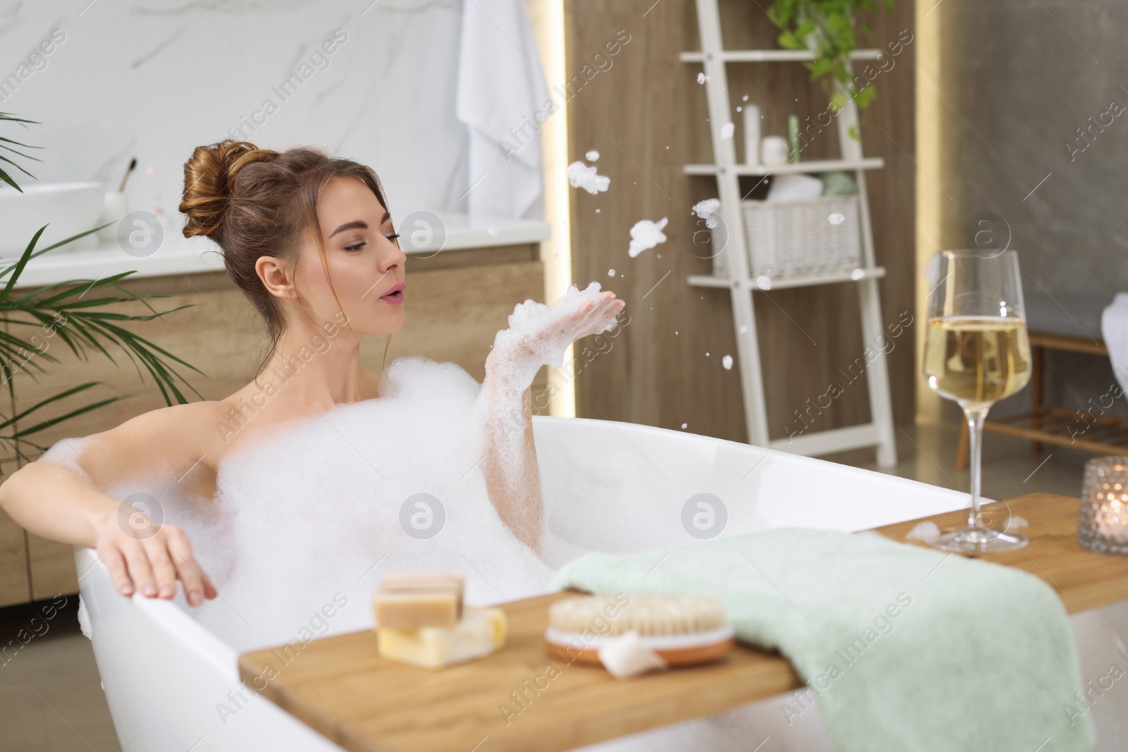 Photo of Beautiful woman enjoying bubble bath at home