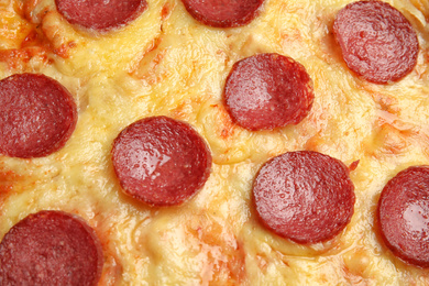 Photo of Tasty pepperoni pizza as background, closeup view