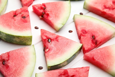 Photo of Watermelon slices on white wooden background, closeup