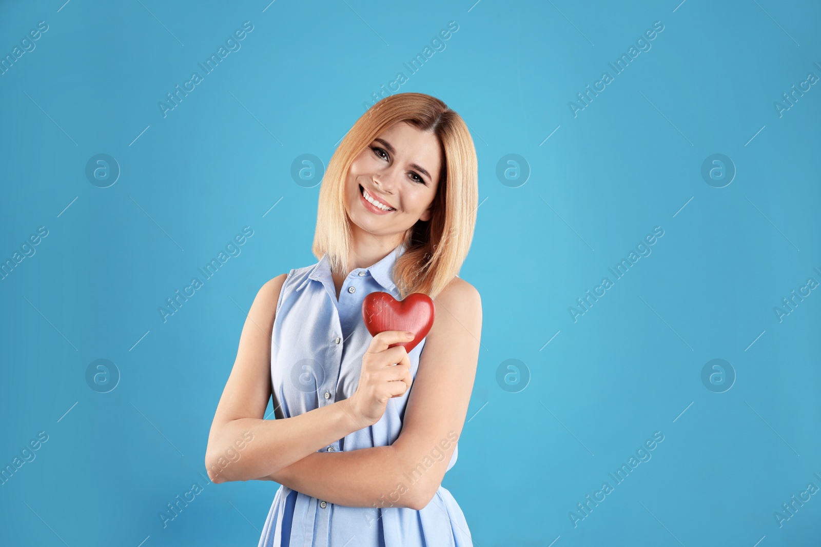 Photo of Portrait of beautiful woman with decorative heart on color background. Space for text
