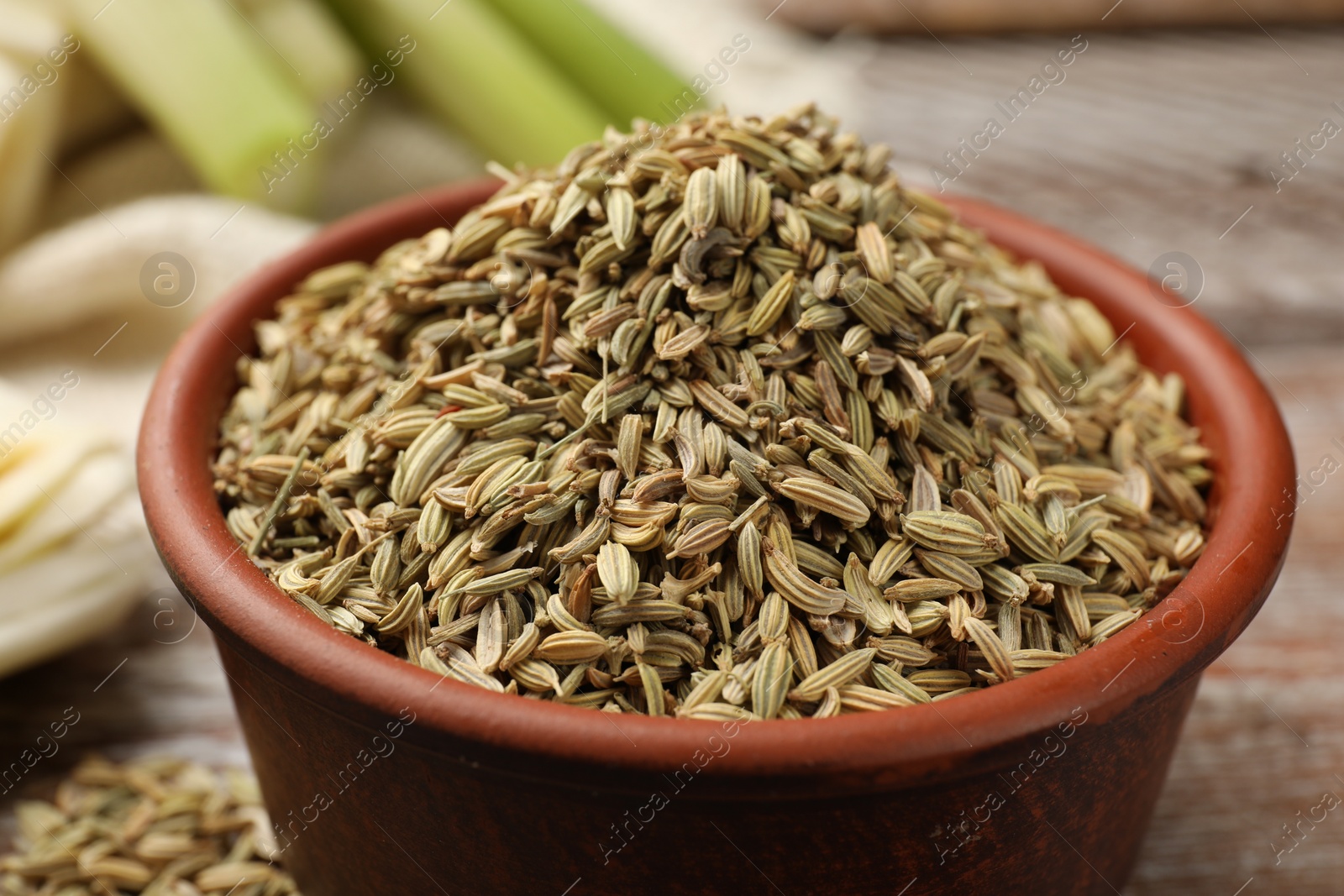 Photo of Fennel seeds in bowl on table, closeup