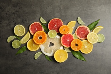 Photo of Different citrus fruits on grey background, top view