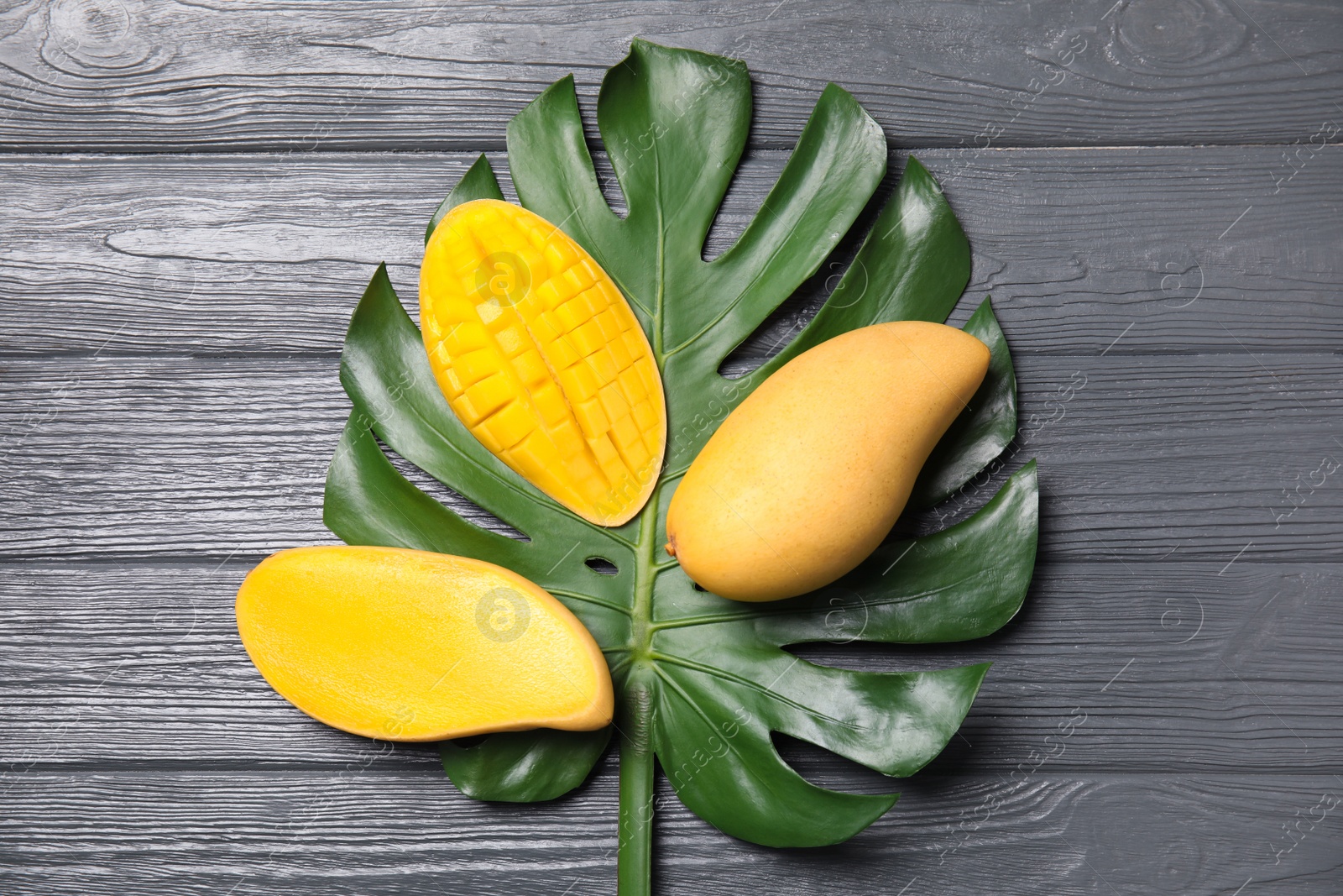 Photo of Flat lay composition with mango and tropical leaf on wooden background